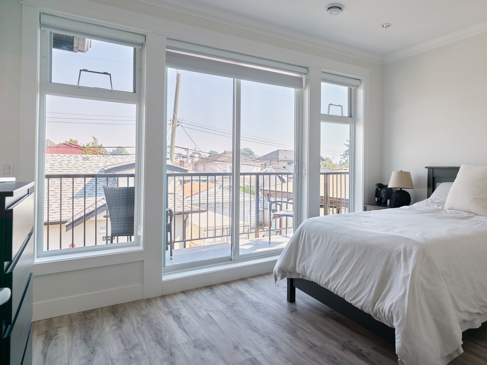 Bright bedroom with floor-to-ceiling windows and balcony