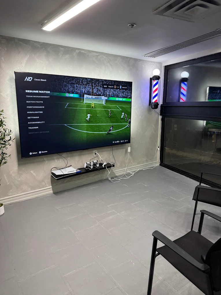 Lounge with PS5 and large wall-mounted screen for guests