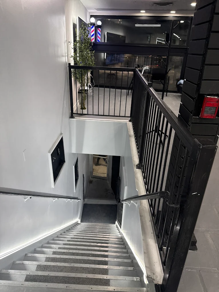 Entrance staircase leading up to the second-floor shop with barber pole
