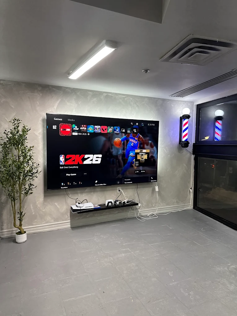 Lounge area with PS5 and large screen for guests